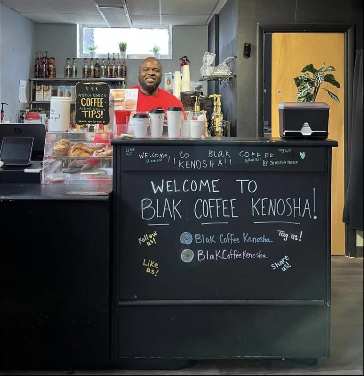 DeShaun Foster welcoming guests from behind the original BLAK Coffee counter